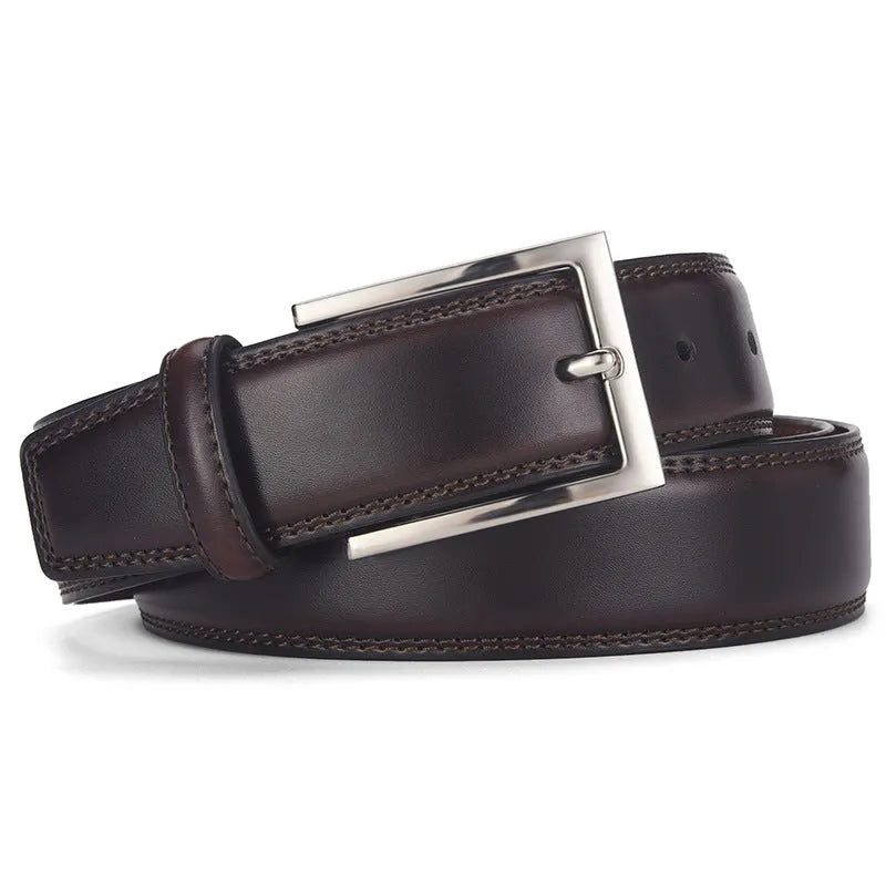 Men's black leather belt with a silver alloy pin buckle on a wooden background.