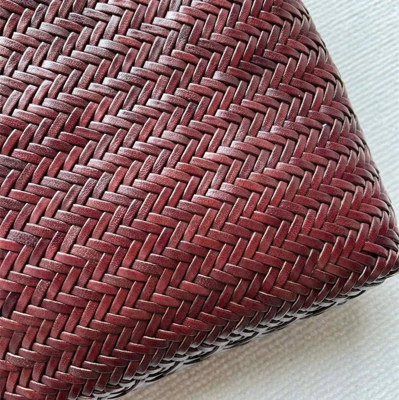 Brown handmade woven tote bag with three-dimensional pocket design and cowhide leather construction