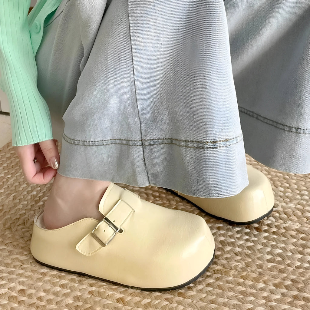 Flat buckle casual sneakers in yellow, creamy-white, silver, and black colours on a white background.