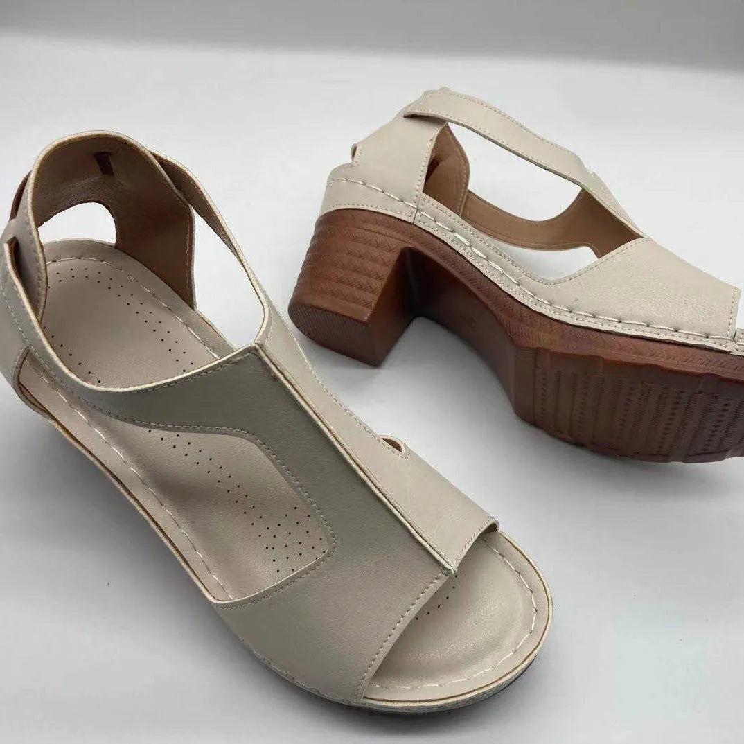 Plus size beige wedge sandals with peep toe, open sides, and a Roman-style ankle buckle.
