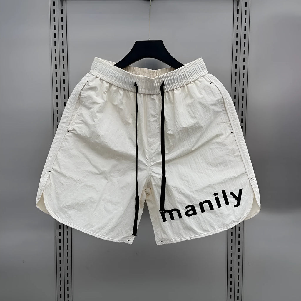 Men's lightweight polyester casual summer shorts in black or apricot with medium elastic waist, sizes M to 3XL