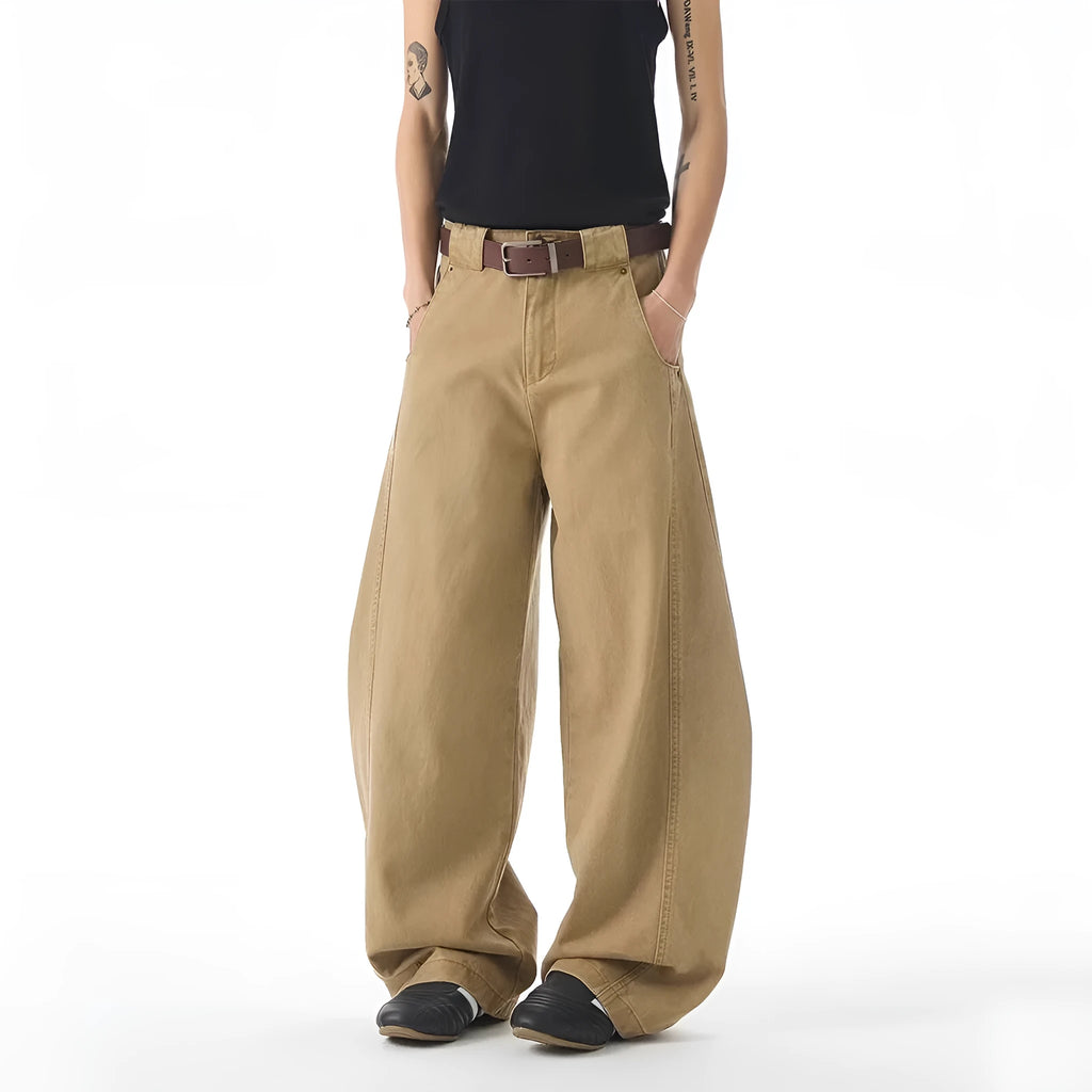 Brown men's straight-leg denim jeans with a loose fit and button fly on a neutral background.
