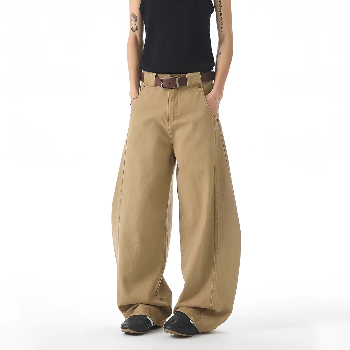 Brown men's straight-leg denim jeans with a loose fit and button fly on a neutral background.