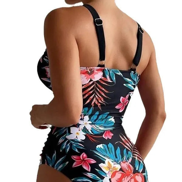 Women's black floral pattern backless one-piece swimsuit laid flat.