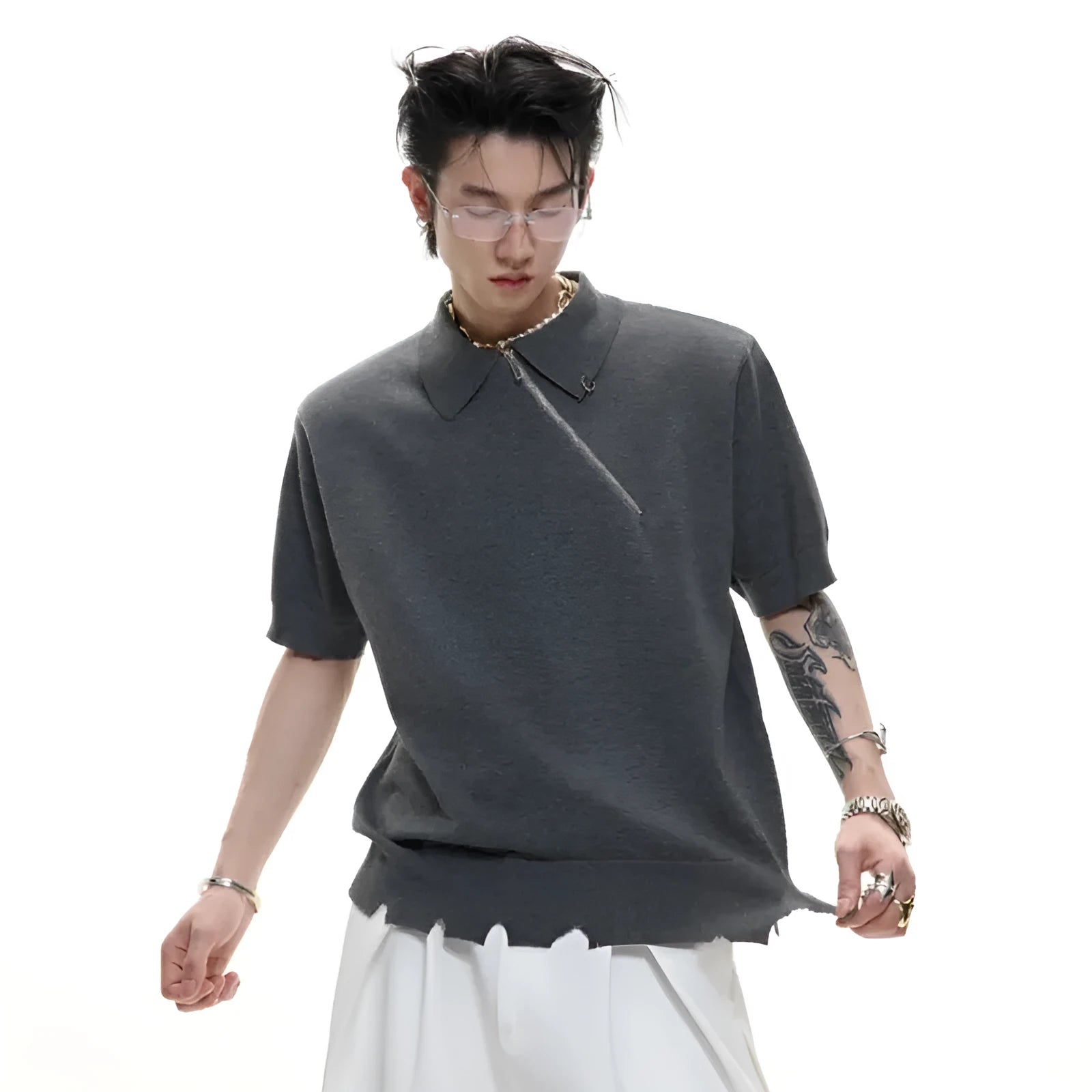 Man modelling a slim-fit black knitted polo shirt with a diagonal oblique zip and lapel collar.