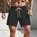 Men's loose-fit track shorts in polyester available in five solid colours with straight-leg design