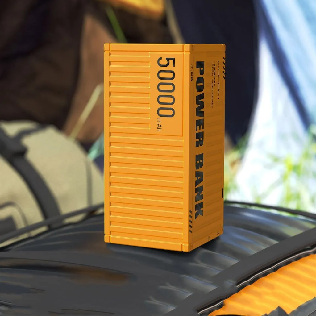 Yellow 50,000mAh power bank with digital display showing battery percentage and five output ports