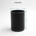 Small round black leather pen holder container on a desk
