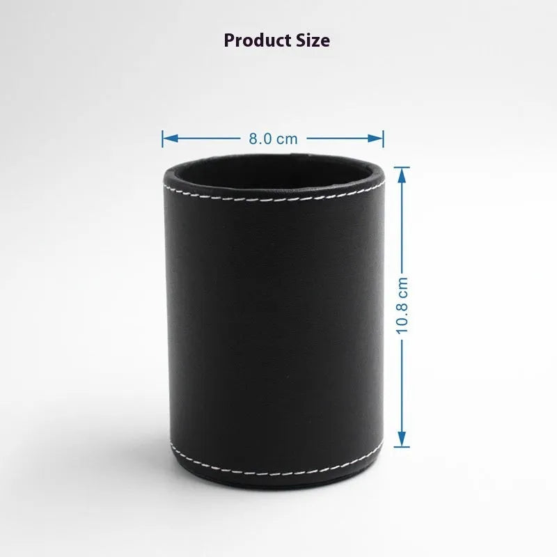 Small round black leather pen holder container on a desk