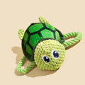 Turtle-shaped plush dog chewing toy with squeaker and hidden knot construction