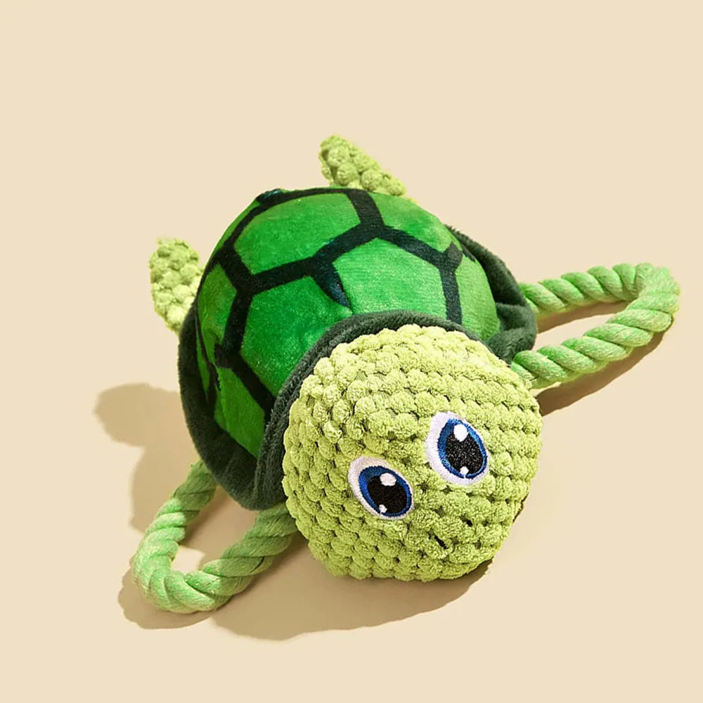 Turtle-shaped plush dog chewing toy with squeaker and hidden knot construction