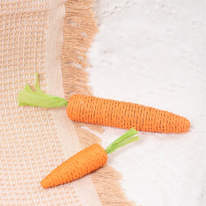 Carrot-shaped paper toys, plastic ringing stones, and textured cat sticks for interactive pet play