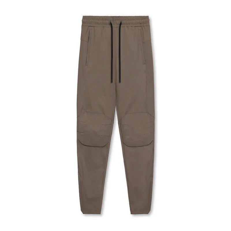 Man wearing loose grey ankle-tie fitness trousers suitable for running and gym workouts.
