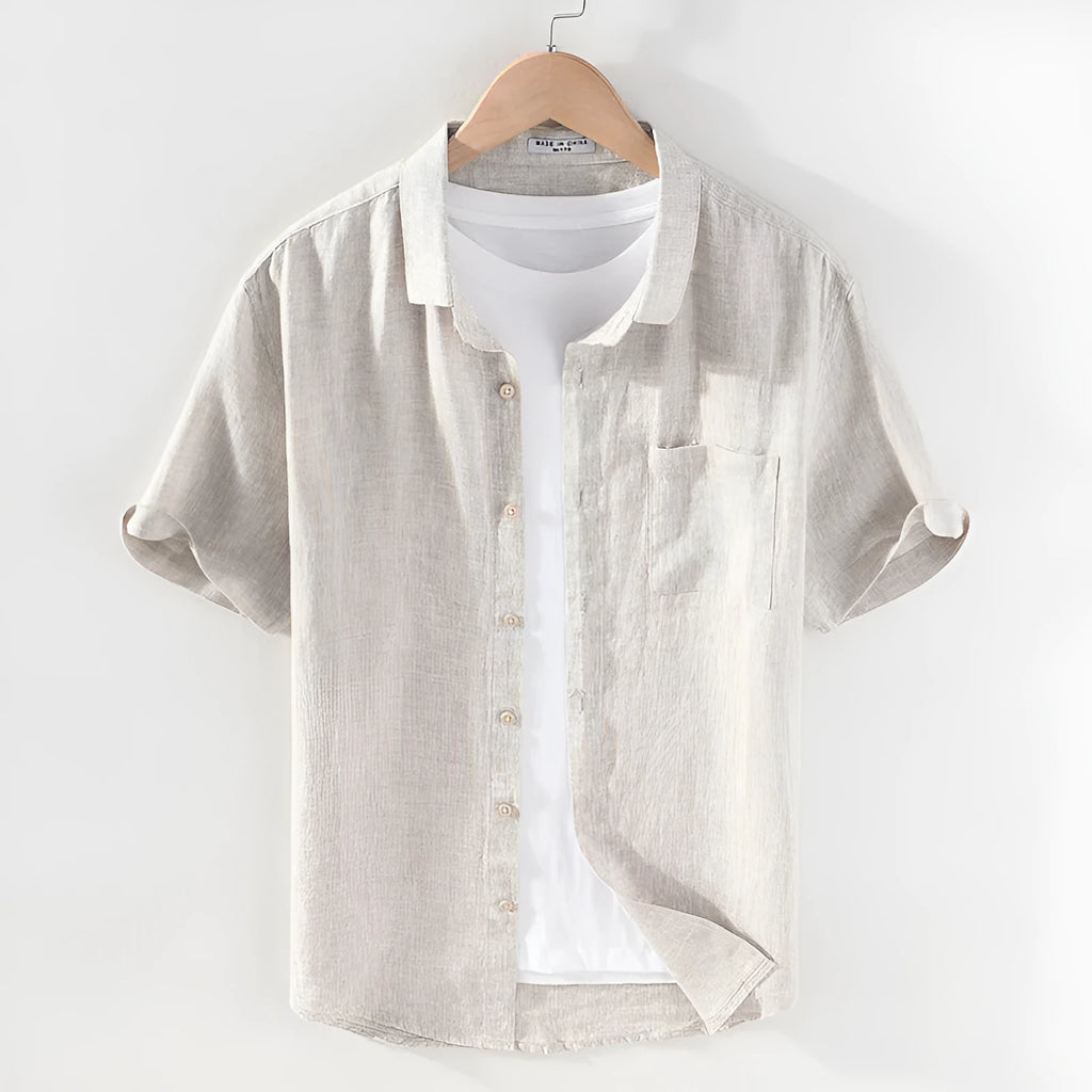 Man wearing a raw jute coloured short sleeve linen shirt with a square collar, showing the casual cardigan style.