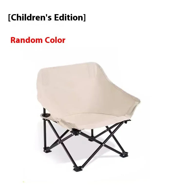 Beige folding camping chair with reclined back and steel frame on grass.