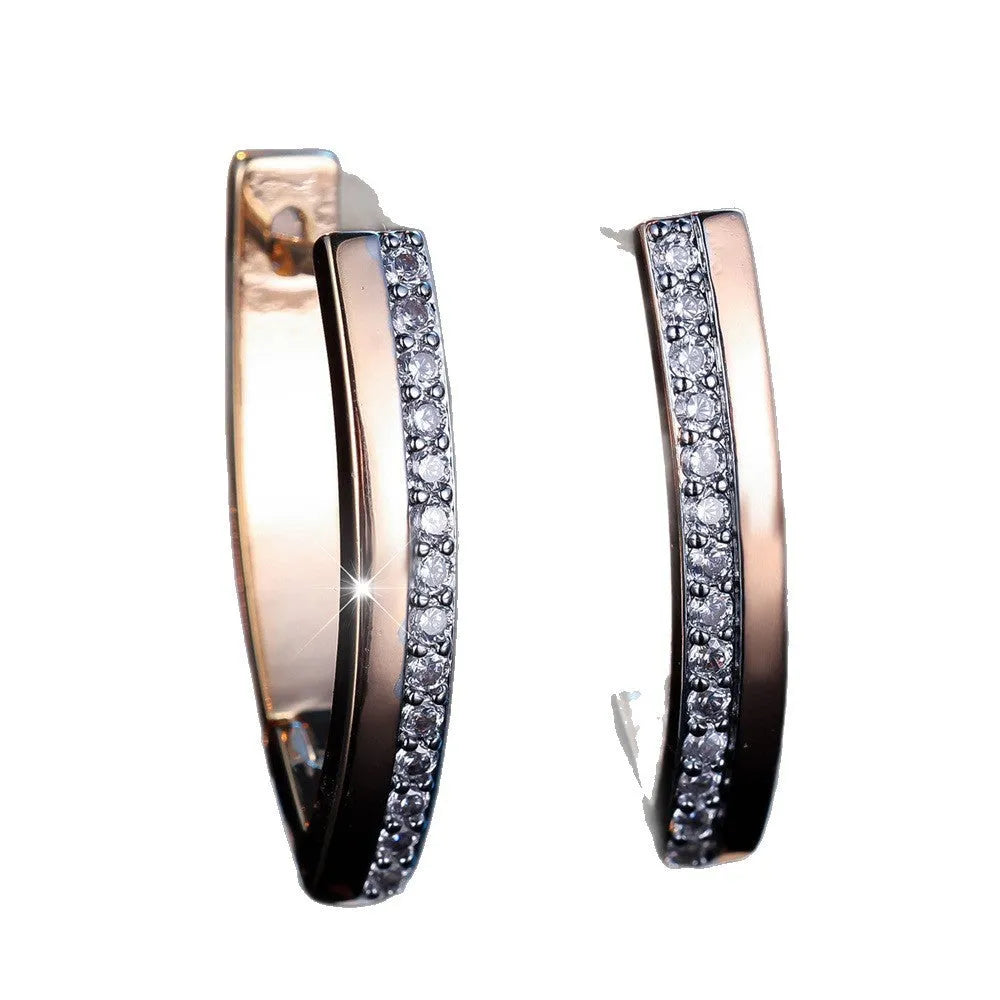 Geometric V-shaped champagne gold women's ear clips with white diamond accents.