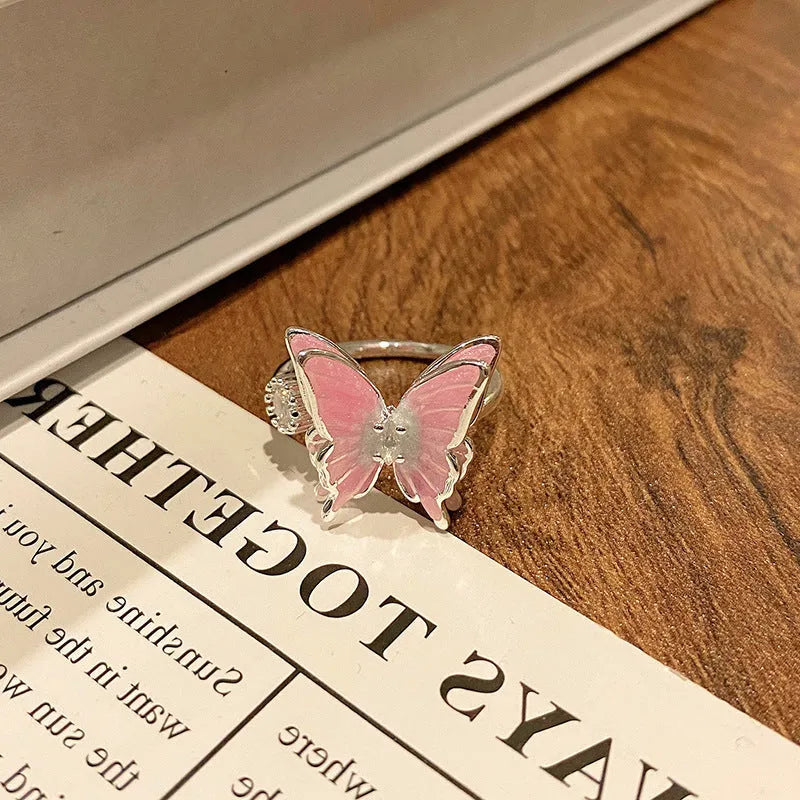 Copper butterfly women's ring with drip oil finish in an open-loop design.
