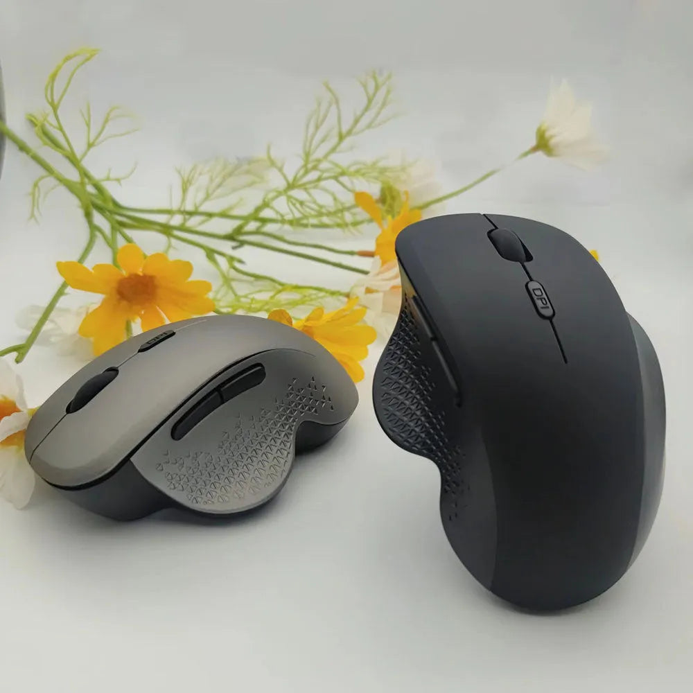 Grey and black self-charging wireless optical mouse for laptop computers with USB receiver and charging cable.