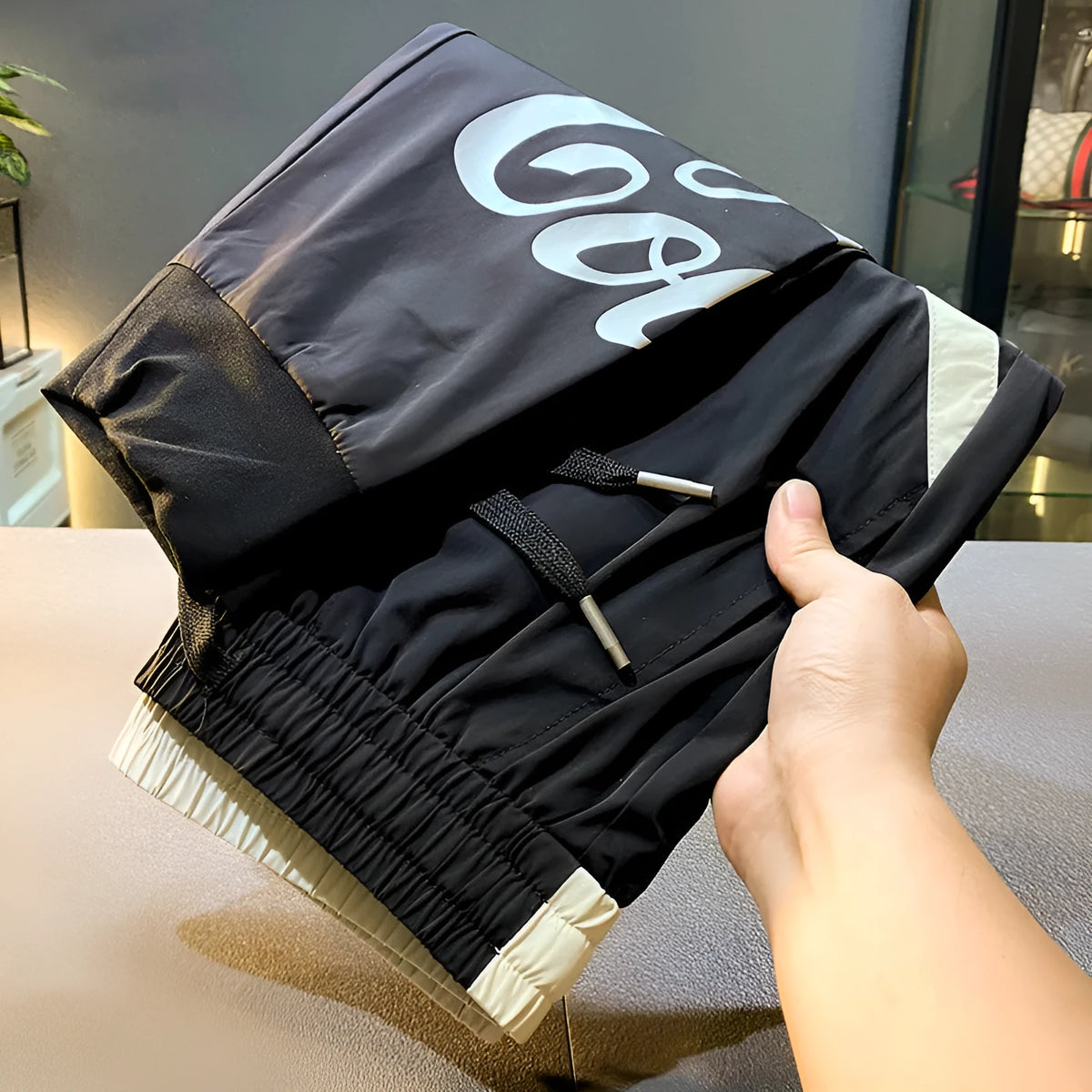Black ultra-thin ice silk ankle banded cropped trousers for men displayed flat