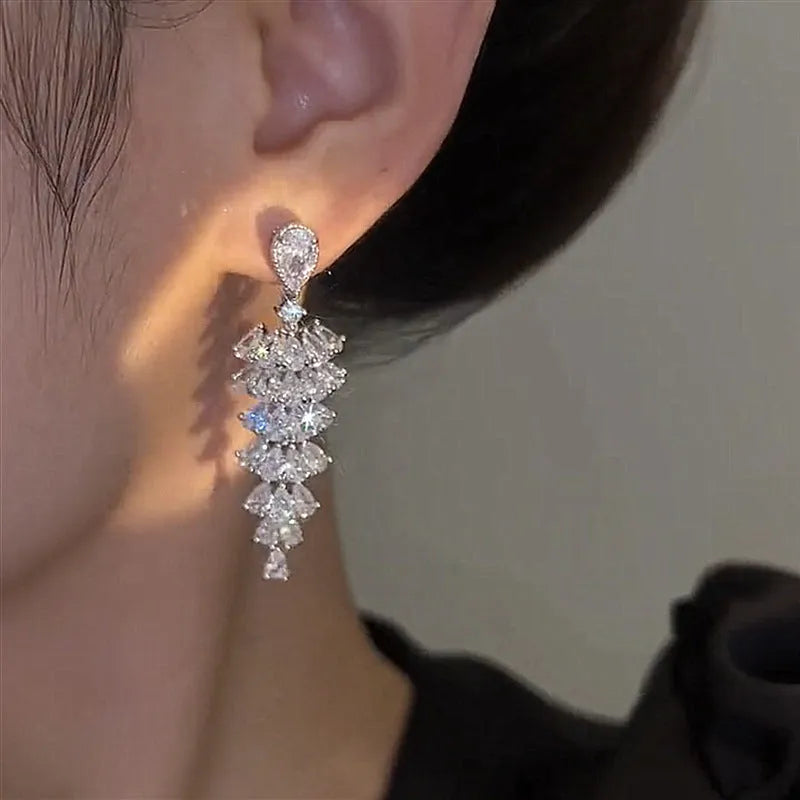 Silver Pagoda colour Christmas tree shaped drop earrings with stud fastenings and sparkling zircon finish.