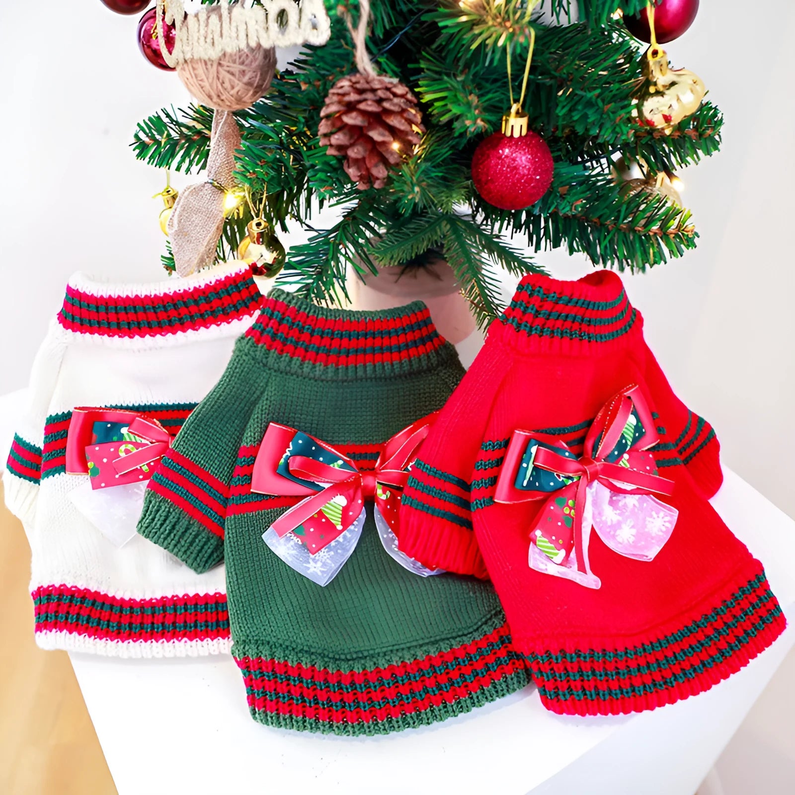 Red and green dog Christmas jumpers showing festive knit design for small to large pets.