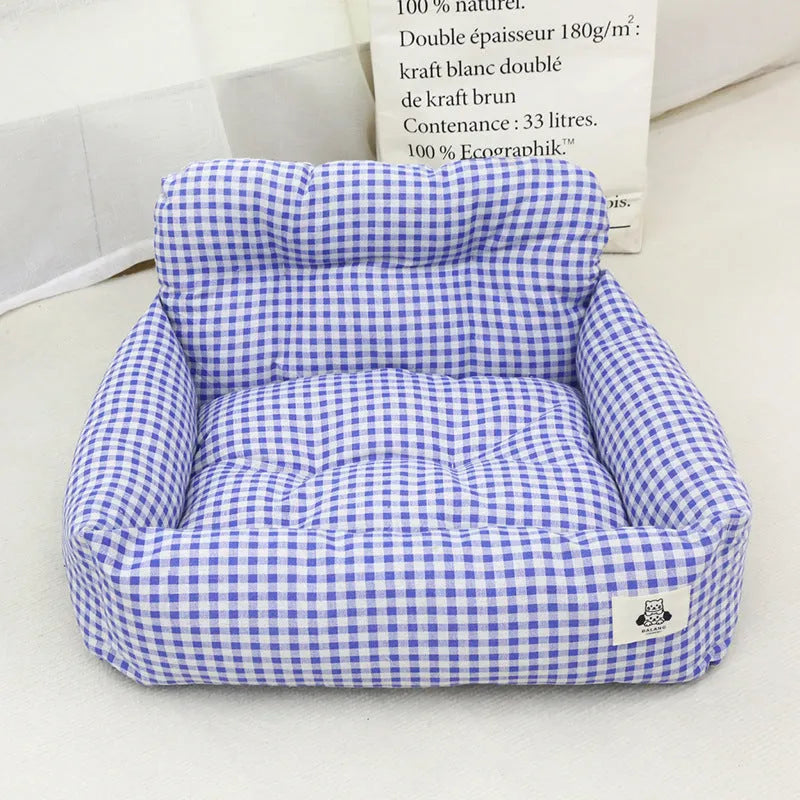 Car-mounted pet travel nest in stain-resistant cloth fabric showing grey and blue plaid options