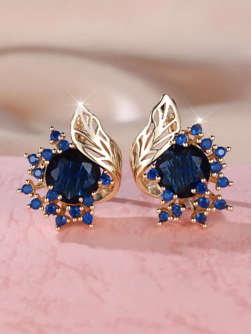 Round flower feather design earrings for women in champagne gold with colourful zircon stone accents.