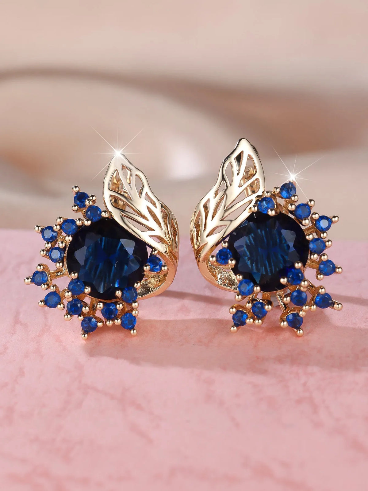 Round flower feather design earrings for women in champagne gold with colourful zircon stone accents.