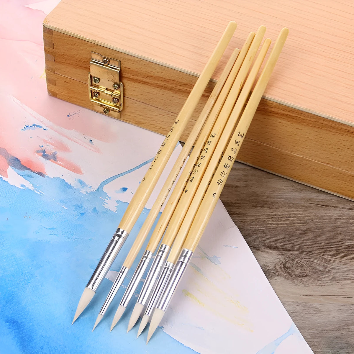 Six wooden-handled artist pen brushes with pointed wool hooks for detailed line work.