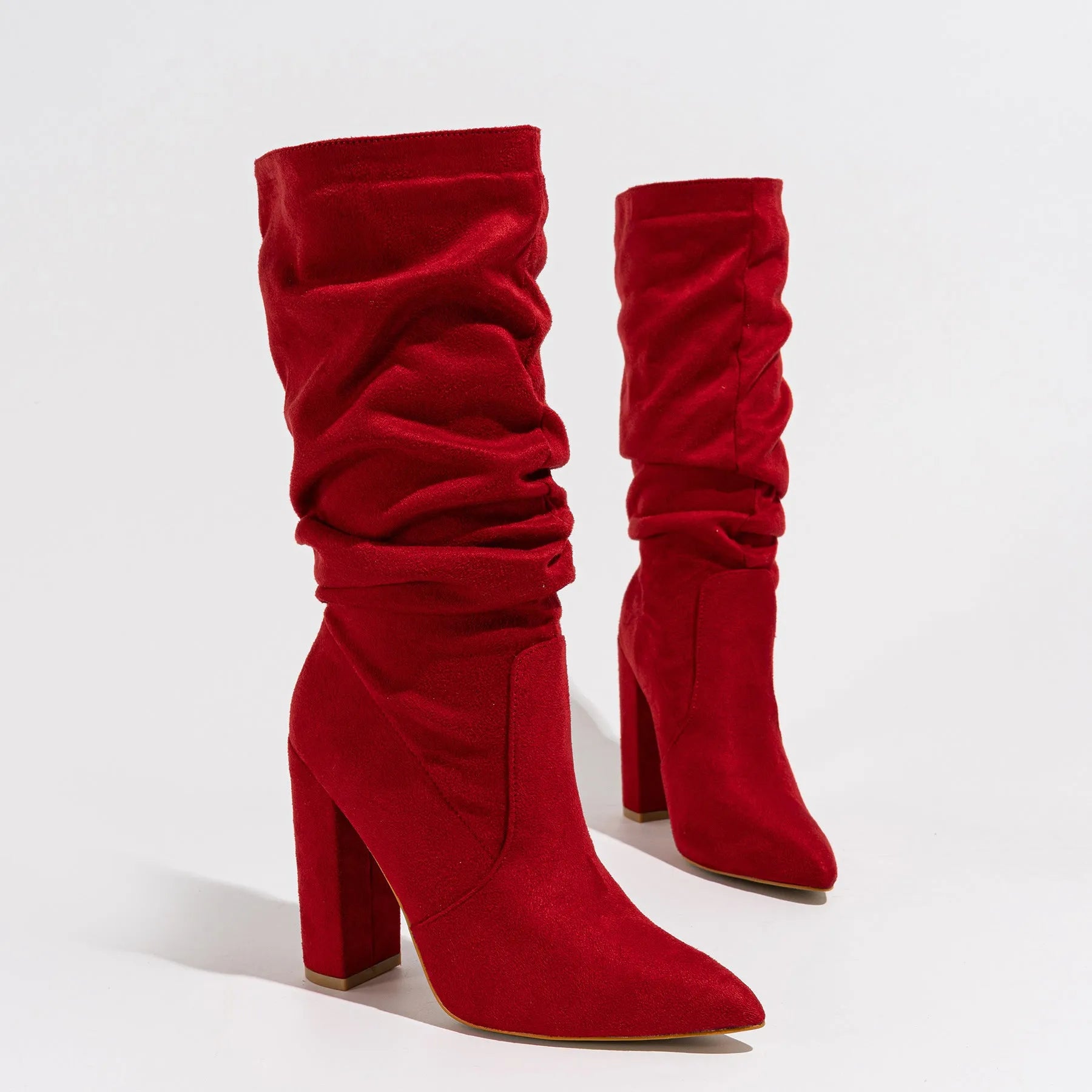 Women's black suede boots with chunky high heels and pointed toe design