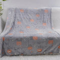 Cartoon print flannel blanket shown in two sizes, suitable for a child or as an air conditioner cover.