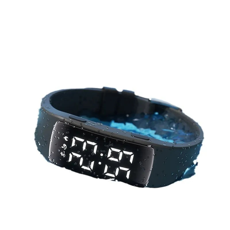 Smart vibration alarm clock watch with coloured silicone strap and LED display on a wrist.