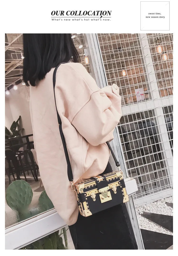 Women's black hard PU leather shoulder bag with single strap and decorative rivet detailing