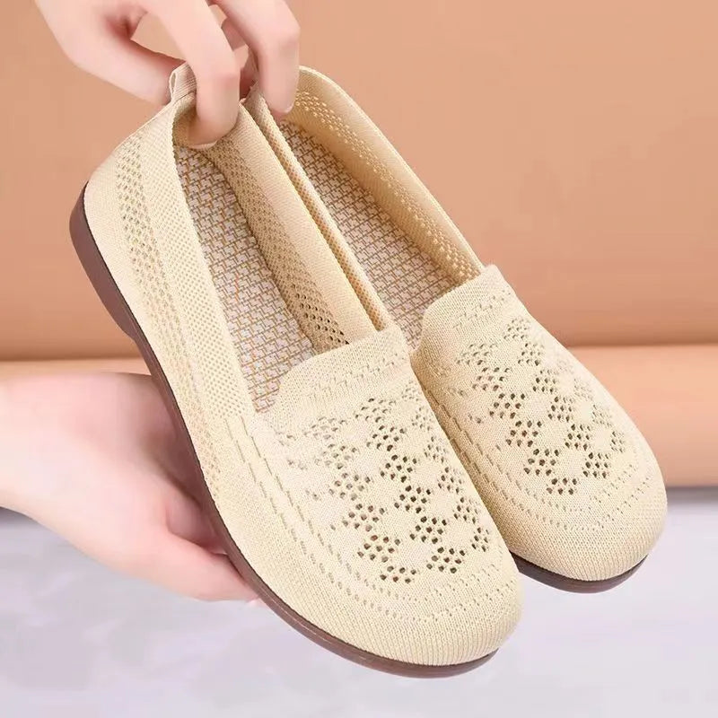 Beige low-top mesh casual trainers for women with a round toe and flat PVC sole.