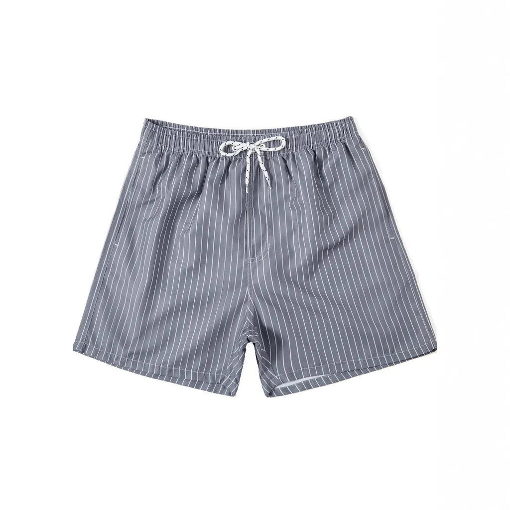 Man or woman wearing striped polyester shorts in navy blue, straight leg style, for beachwear.