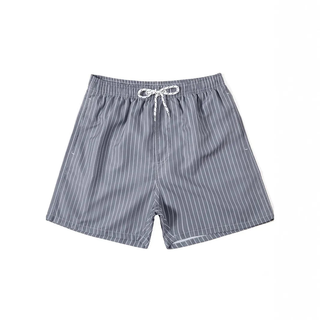 Man or woman wearing striped polyester shorts in navy blue, straight leg style, for beachwear.