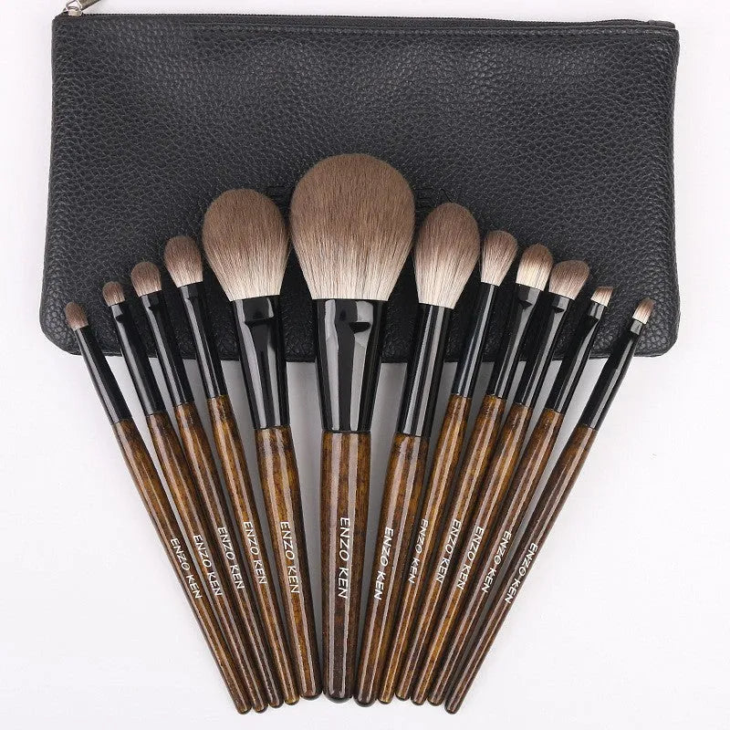 12 makeup brushes with wooden handles stored in a black PU roll, showing the powder foundation brush.