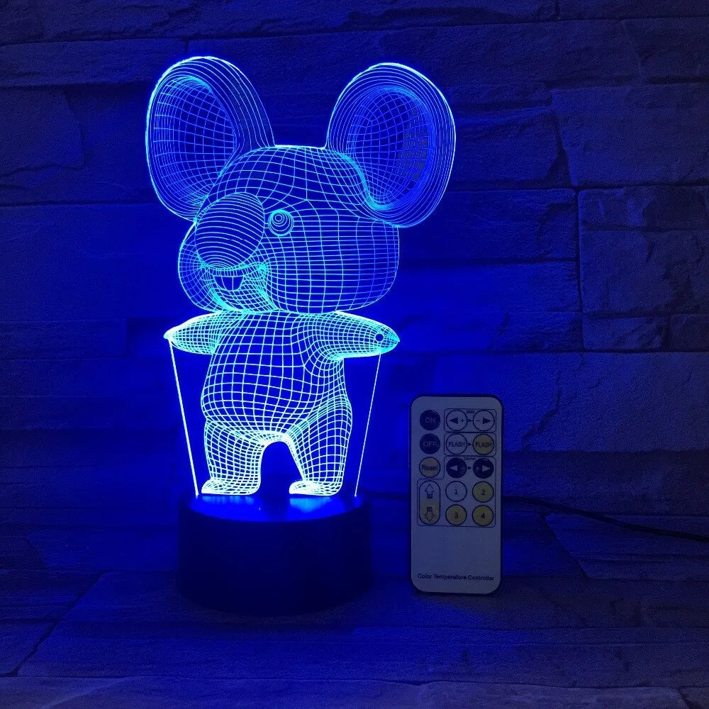 Koala-shaped LED night light with remote control on a bedside table, showing multiple colour options.