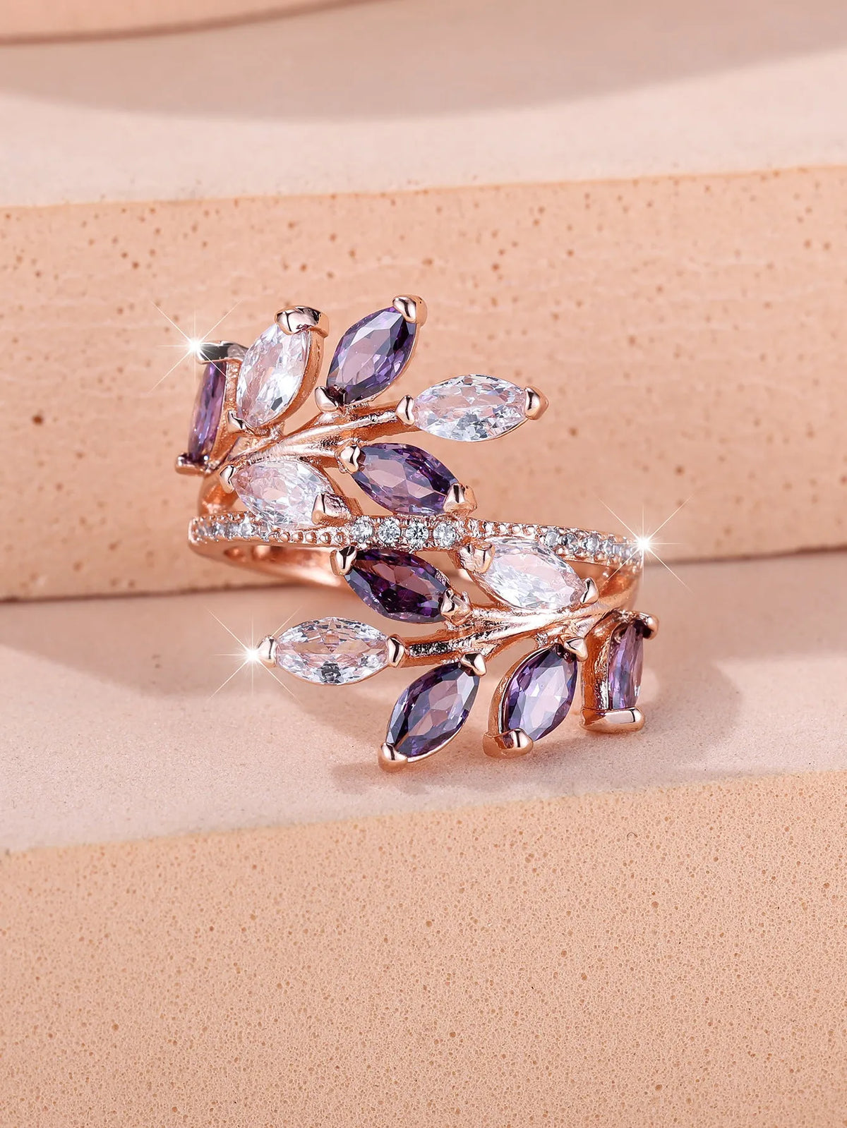 Adjustable copper leaf ring with zircon detailing in multiple colour options on display