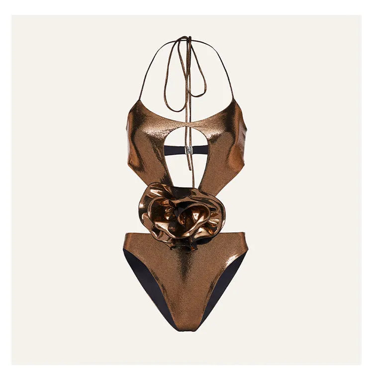 Gold coloured handmade halter neck one-piece swimsuit with hollow-out design on a mannequin.