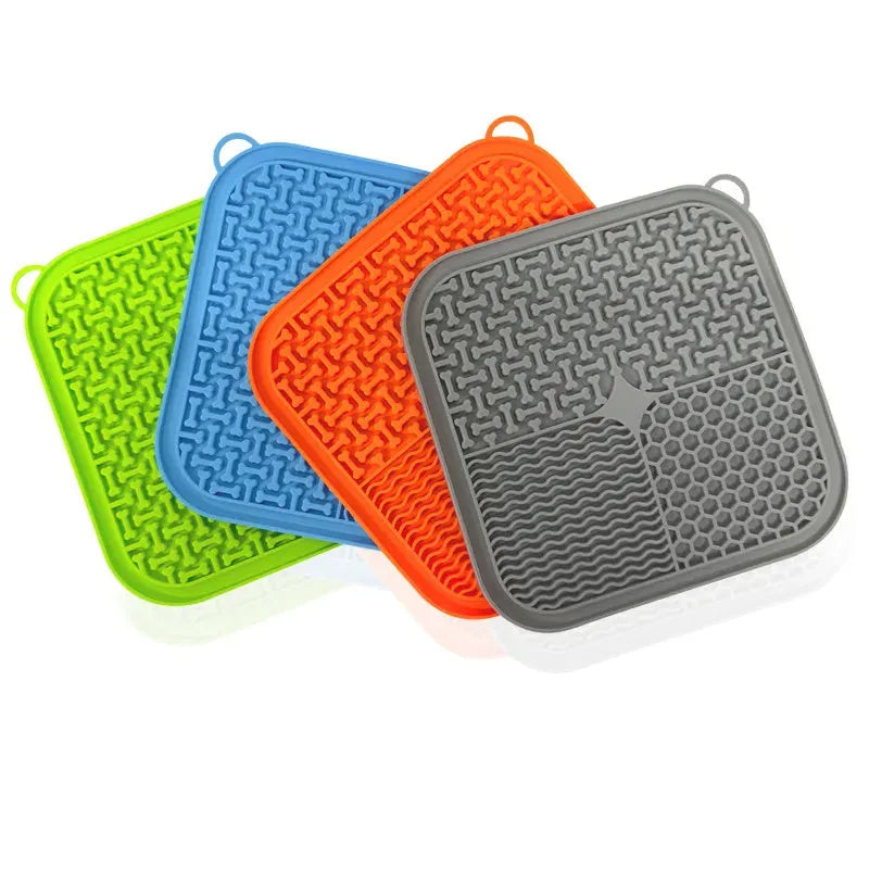 Orange red silicone dog licking mat with suction cups on back for slow feeding and anxiety relief