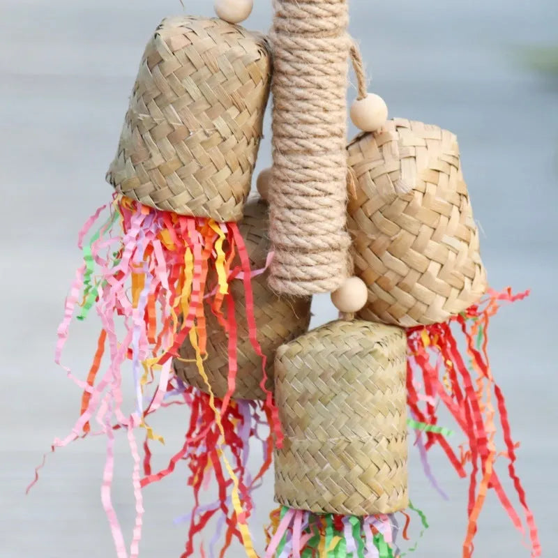 Colourful shredded paper parrot toy with wood and sisal construction measuring 15cm by 35cm