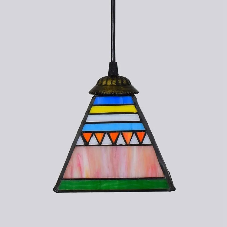 Vintage styled pendant light with a coloured glass shade hanging from an iron ceiling plate.