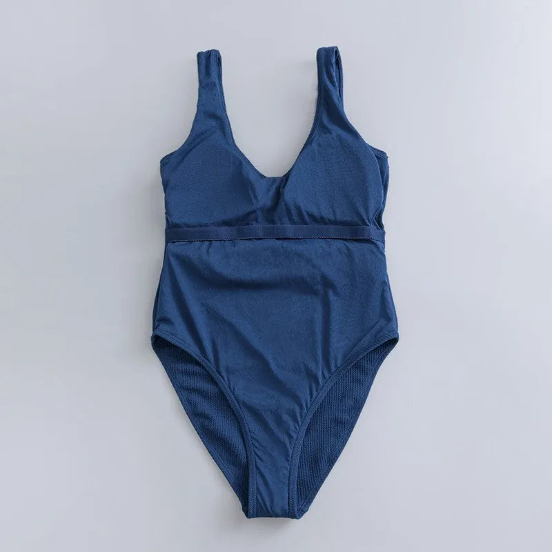 Navy blue women's one-piece swimsuit with triangle design and chest pads
