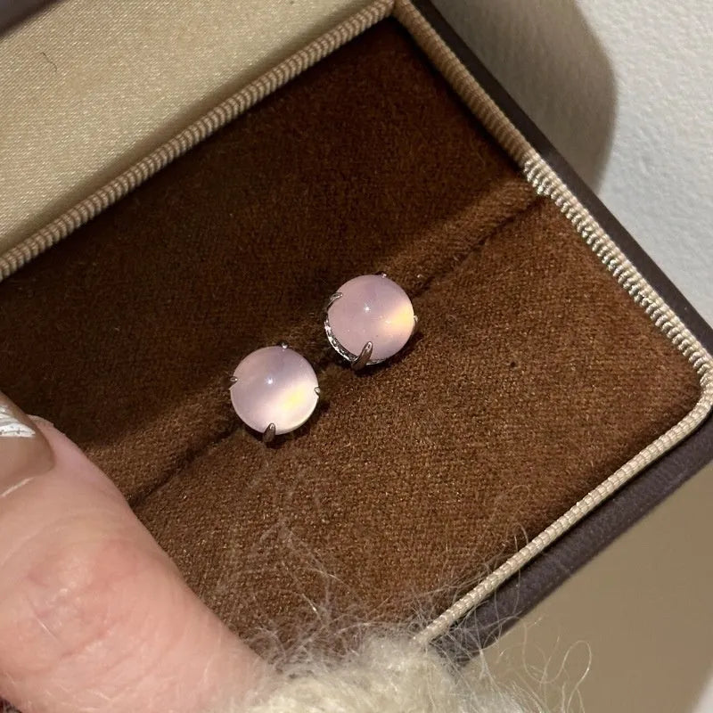 Chinese style chalcedony stud earrings with four-claw stone settings and round geometric design