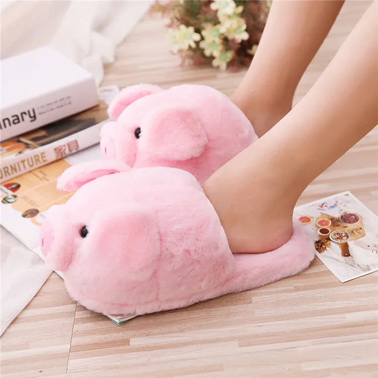 Pink pig-shaped floor slippers with short plush fabric and a soft padded interior.