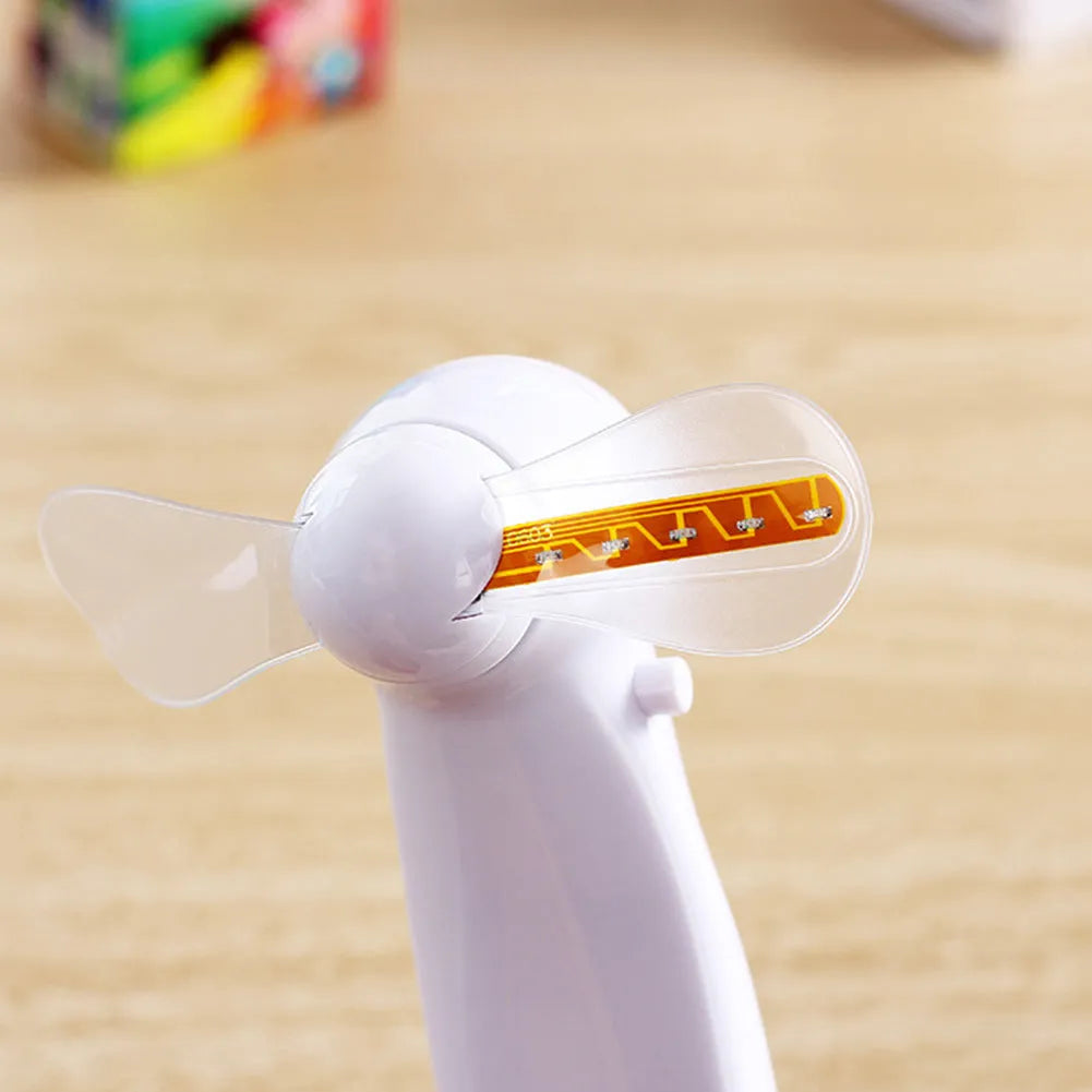 White handheld mini fan with a flashing blue and red LED 'I Love You' heart pattern on the front.