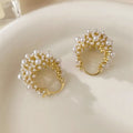 Gold coloured women's flower basket earrings with pearl inlay and small rice-shaped bead details.