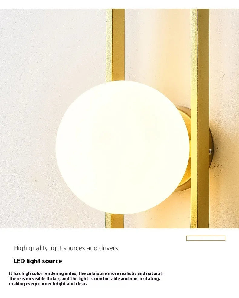 Minimalist modern wall lamp with glass shade and iron body in black finish, mounted on a wall.