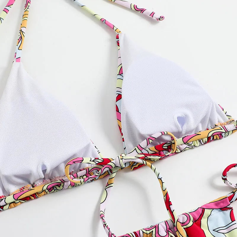 Women's multicolour triangle printed bikini with halter neck top and separate bottoms.